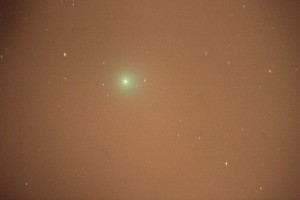 A comet with bad sky glow, vignetting from the optical system, and trailing from imperfect polar alignment
